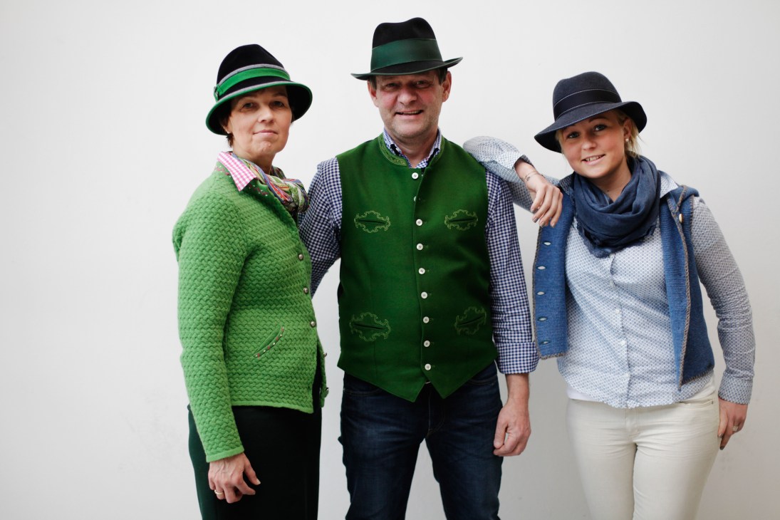 Hatmaker Franz Bittner and his family wear traditional Alpine tracht clothing including embroidered vests, hats and jackets.
