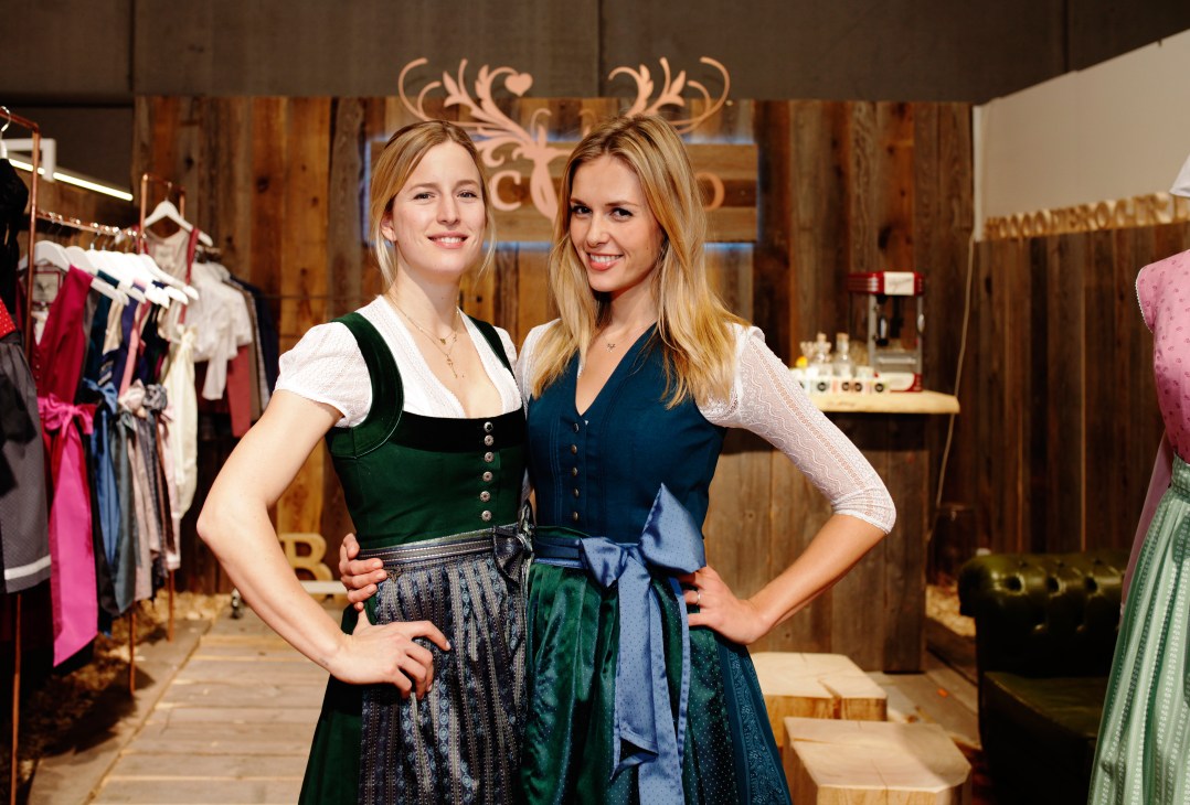 Two women in modern dirndls at Cocovero's stand at the Tracht & Country fair