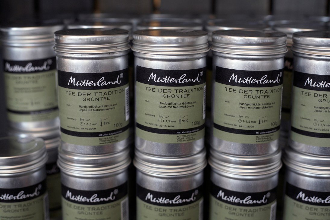 Mutterland tea canisters with black and cream labels stacked in rows at the deli.