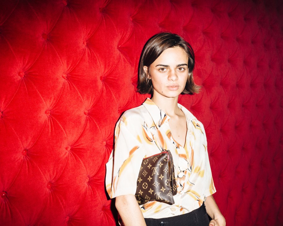 Fashion designer Maria Urquijo poses against a red quilted velvet wall at the ChaChá nightclub in Madrid.