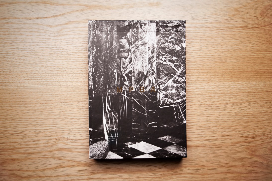 Black and white book titled "Modern History" displayed on wooden surface.