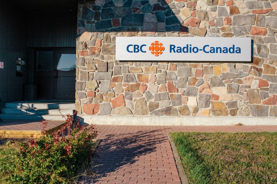 CBC Radio-Canada signage on stone exterior of CBC North headquarters building in Yellowknife.