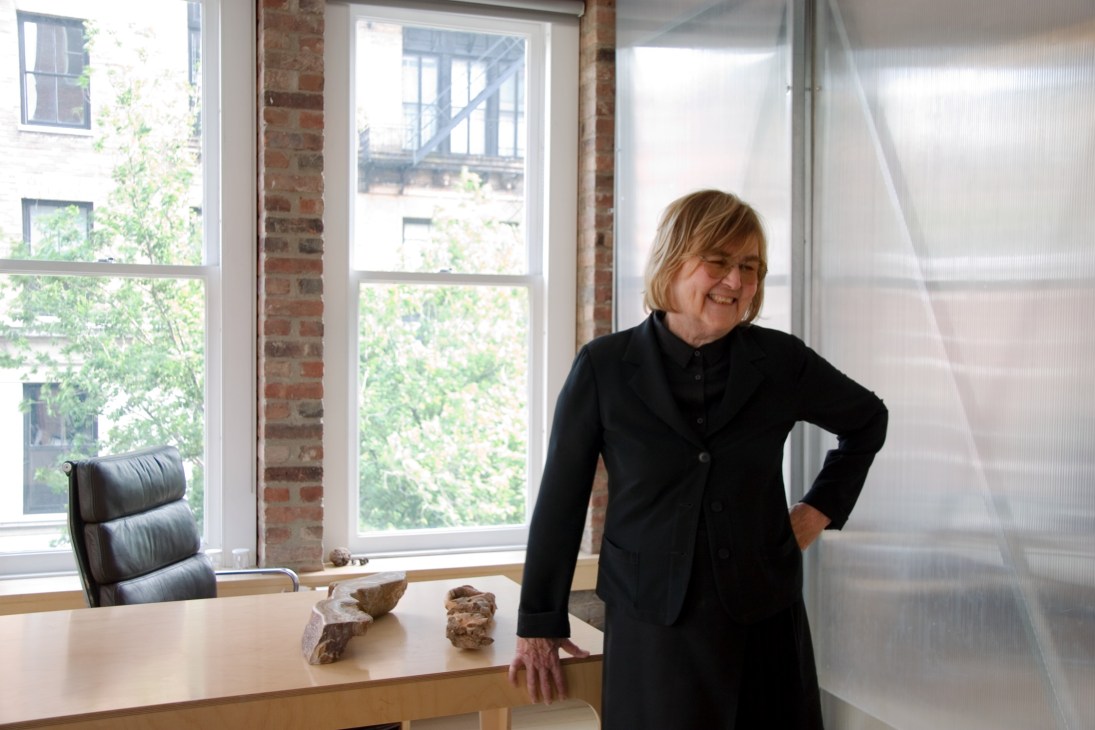 Diana Balmori stands by her desk in her Manhattan office, smiling at the camera.