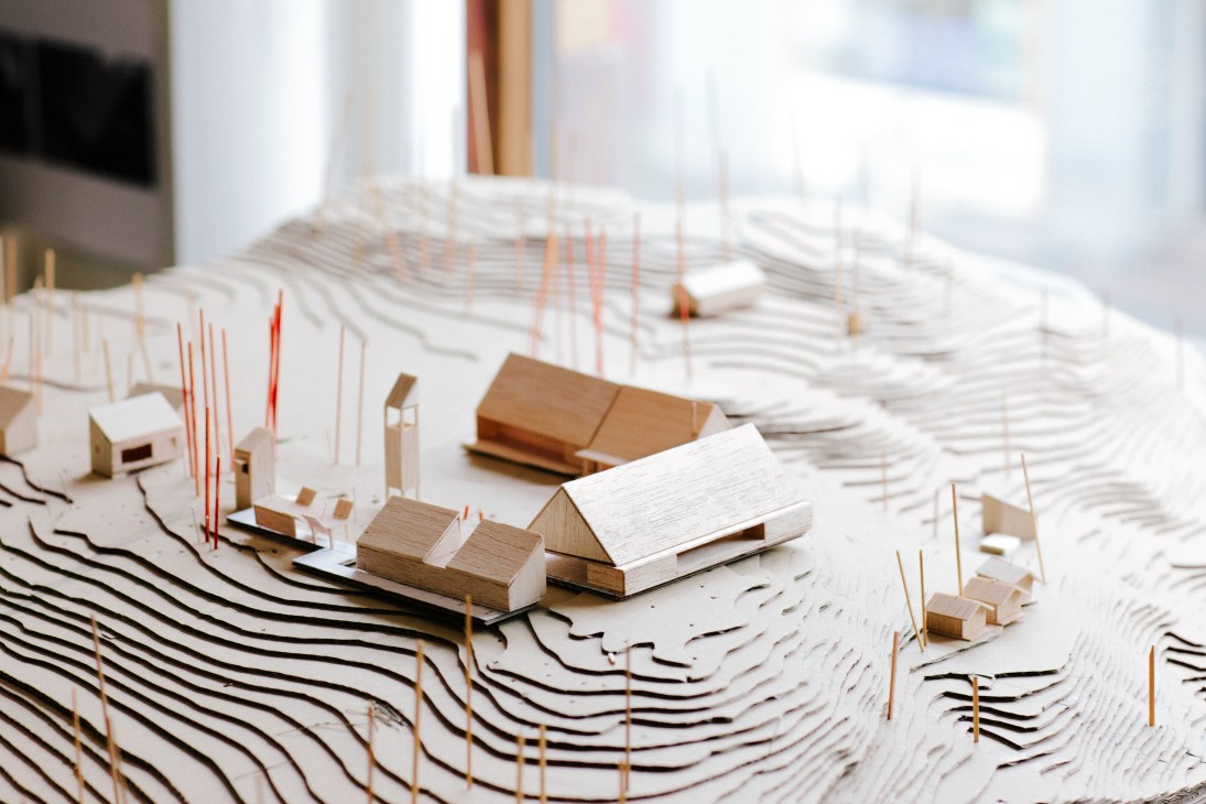 Architectural model showing the new vision for Utøya island with wooden buildings and topographic contours.