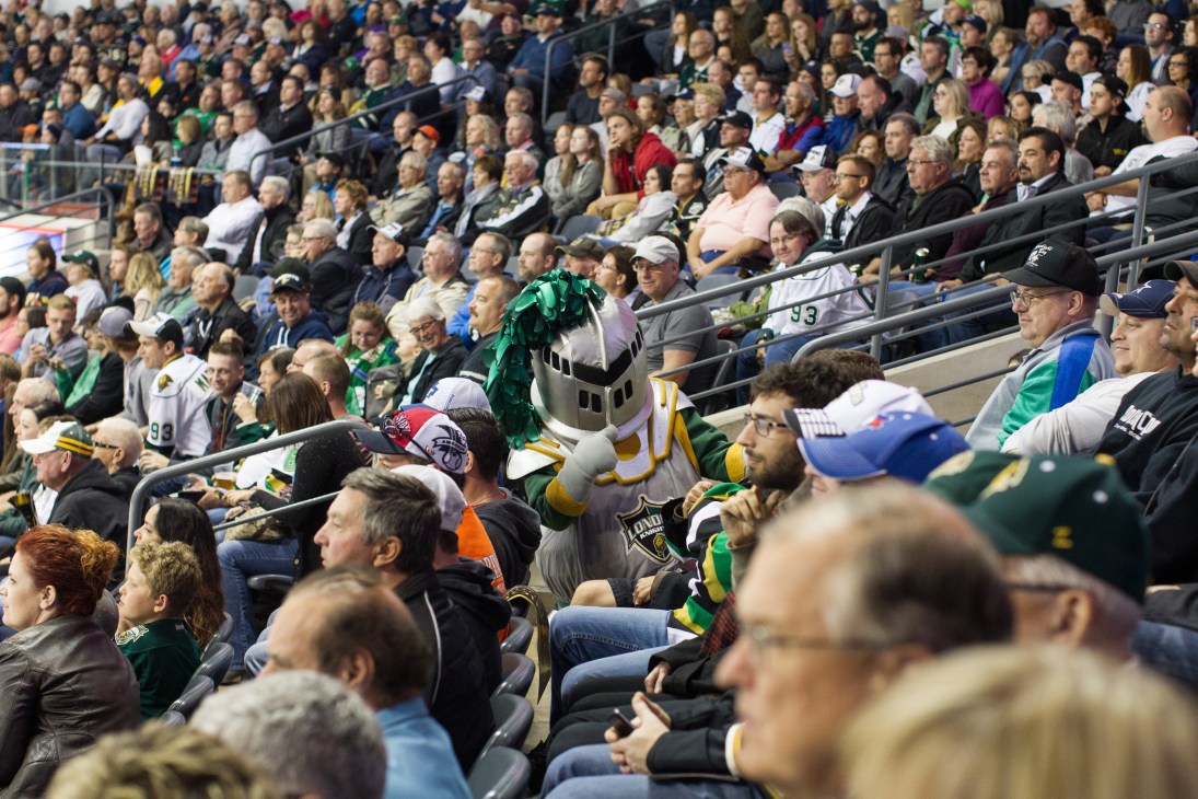 Scorezy, the London Knights mascot, interacting with fans in the crowded arena stands