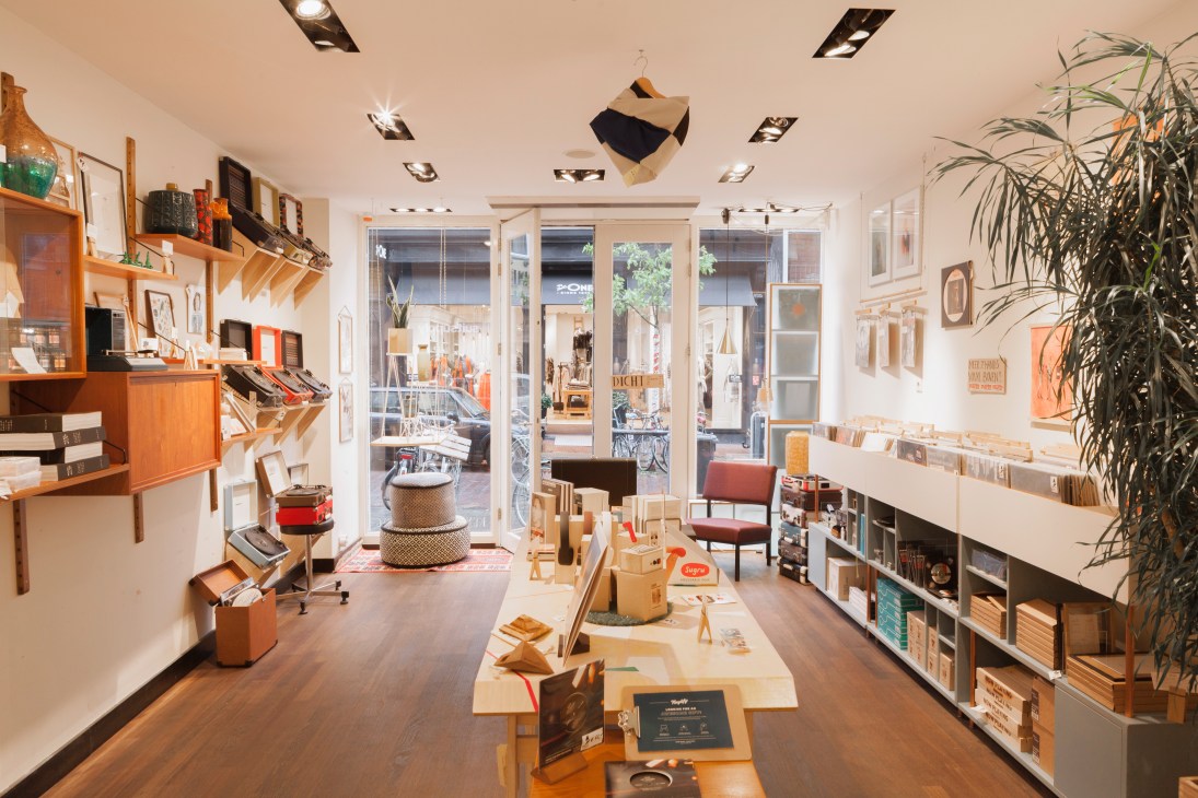 Interior of Swordfish & Friend record shop displaying vinyl records, turntables, and wooden shelving.