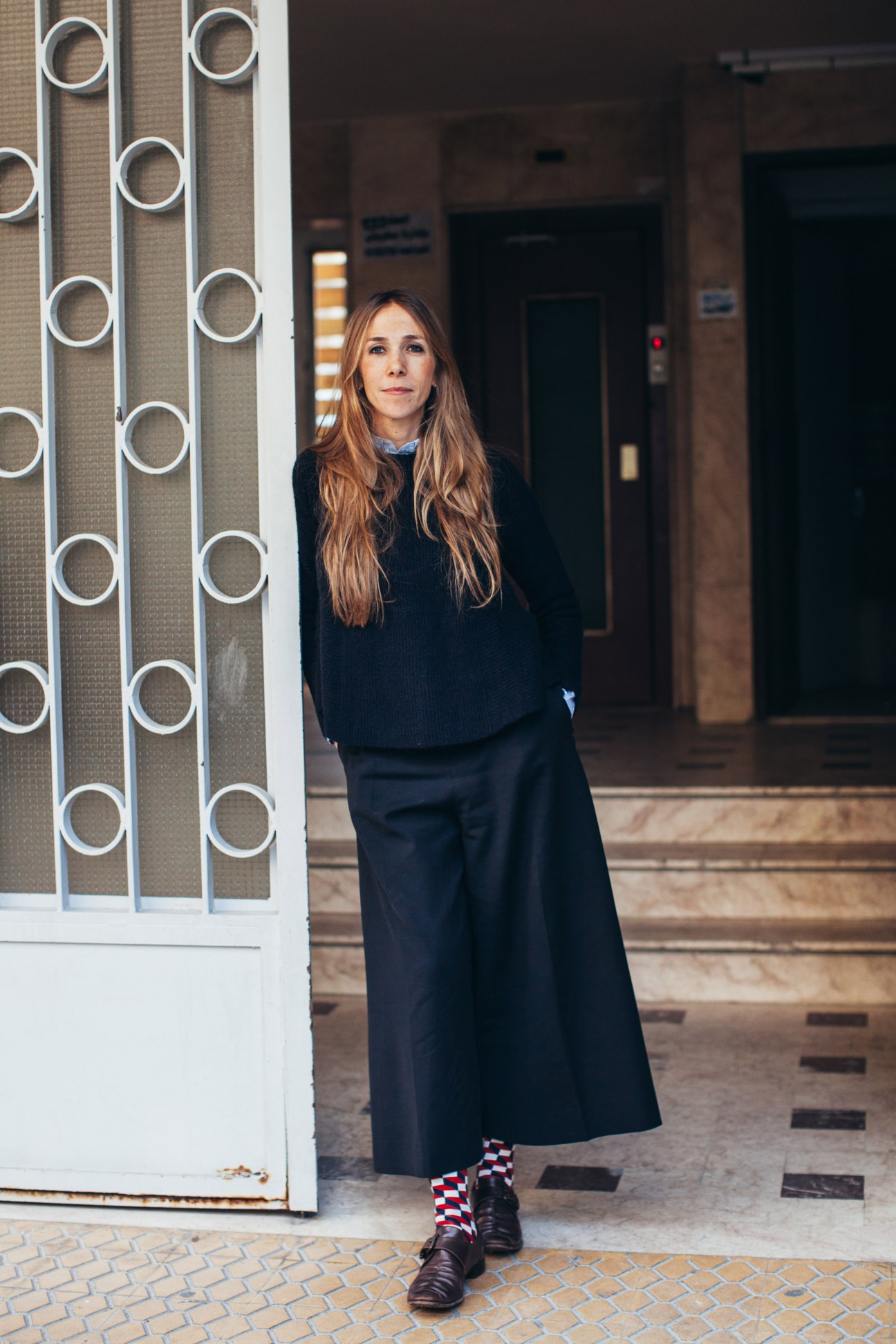 Tala Hajjar of Starch Foundation standing outside a building wearing black clothing.