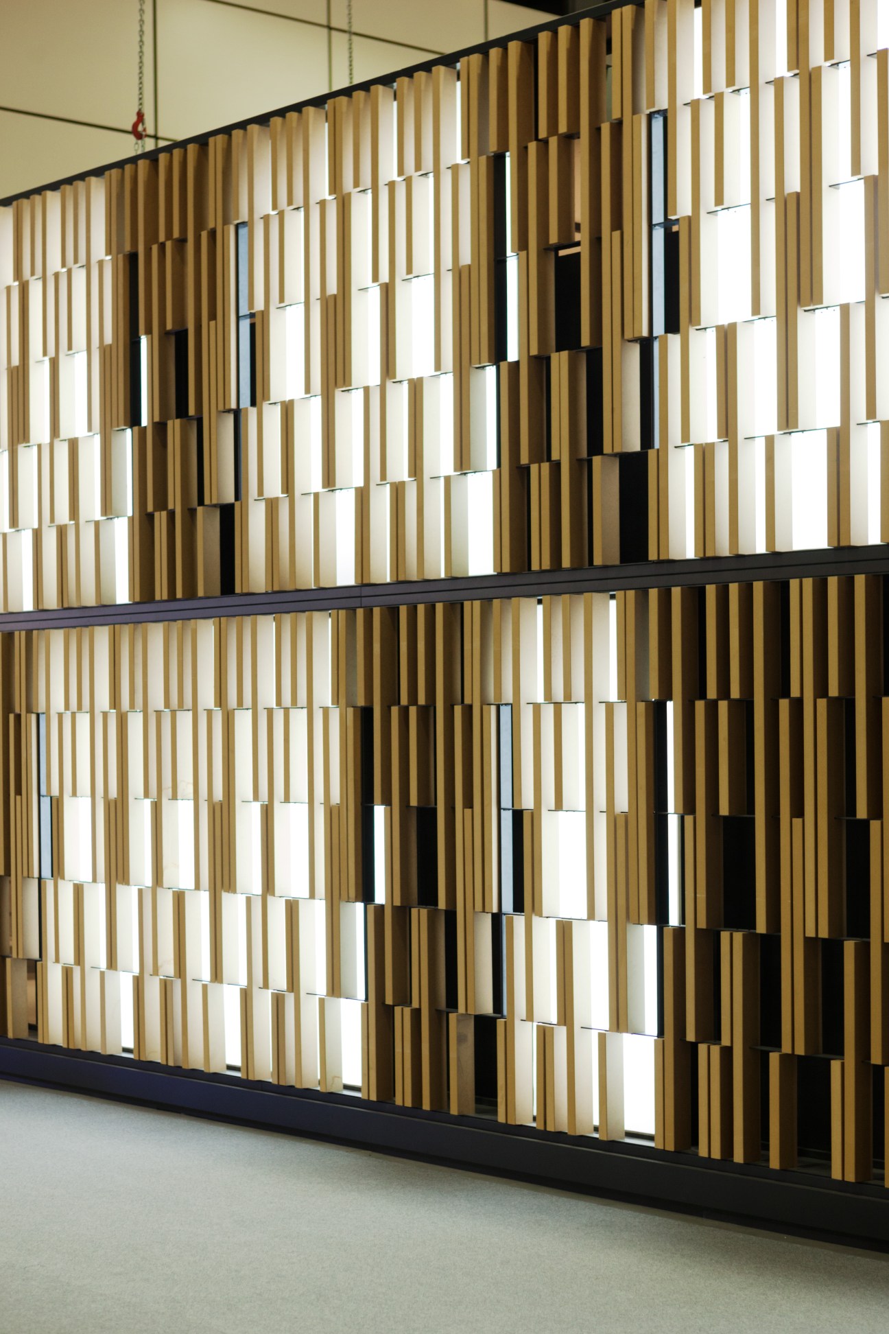 Modular wooden slat display wall with geometric pattern designed by Paolo Cesaretti for Kale stand