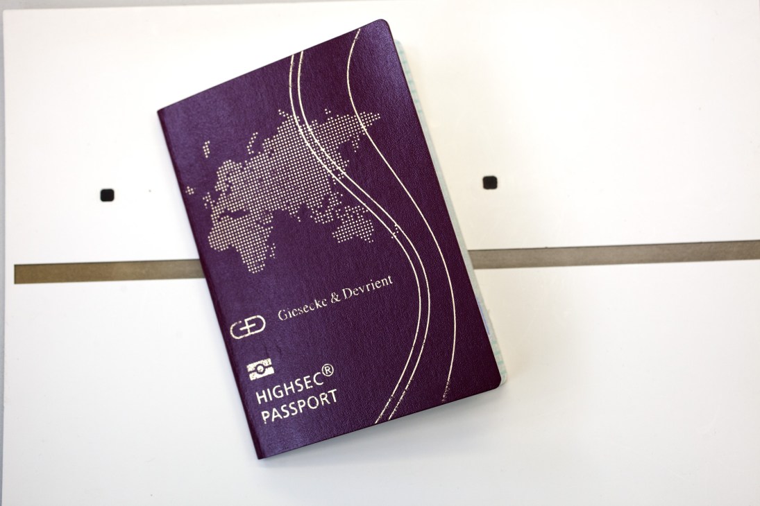 Purple passport with dotted world map and Giesecke & Devrient Highsec Passport branding.