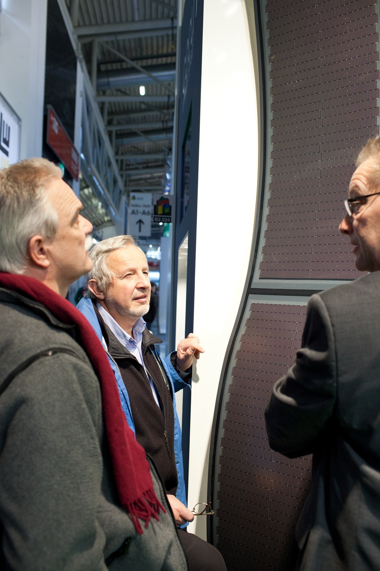 Architects examine photovoltaic panels at Boehme Systems stand at BAU.