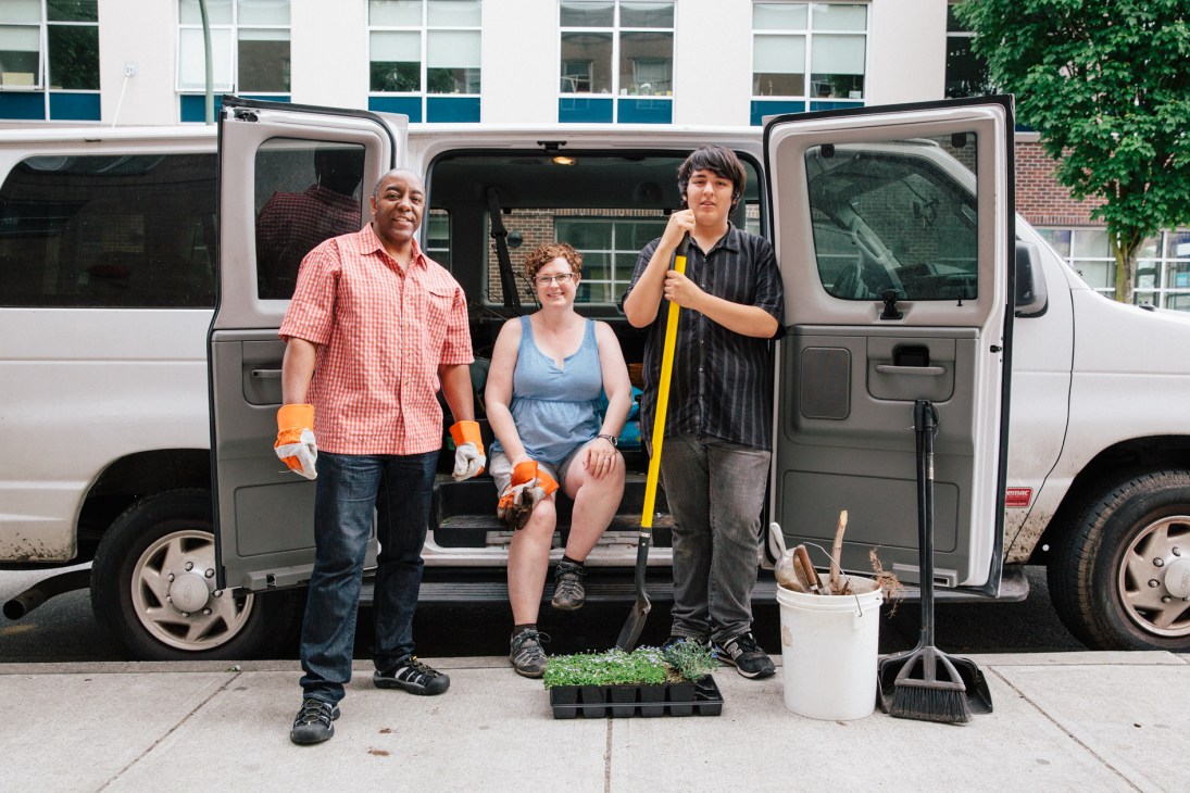 Three volunteers stand in front of a van with gardening tools and seedlings for Vancouver's street beautification program.