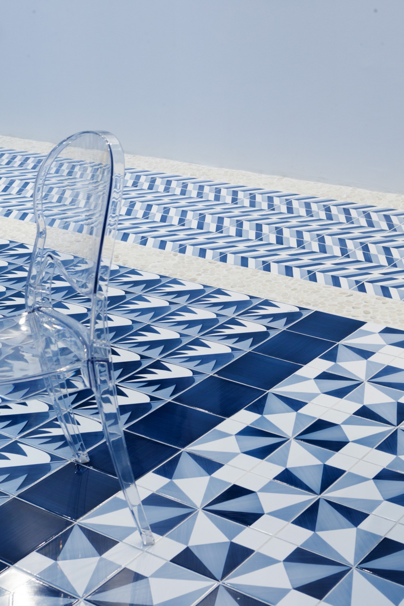 Blu Ponti tiles by Ceramica Francesco De Maio featuring blue and white geometric patterns on floor with clear chair
