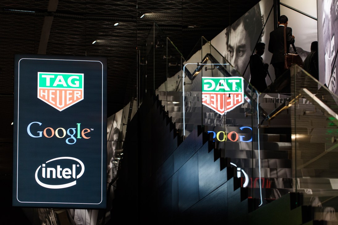 Tag Heuer stand at Baselworld displaying Google and Intel logos on illuminated signs.