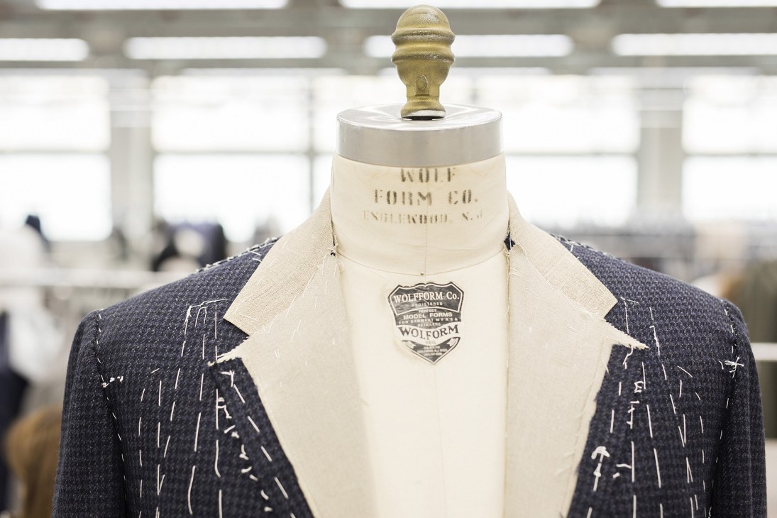 Wolfform Co. dress form displaying a tailored navy pinstriped jacket with hand-marked tailoring lines.