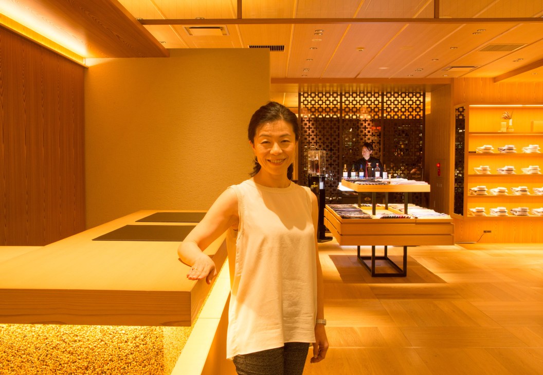 Naoko Tashiro stands in a modern retail space with warm lighting at Isetan Mitsukoshi.