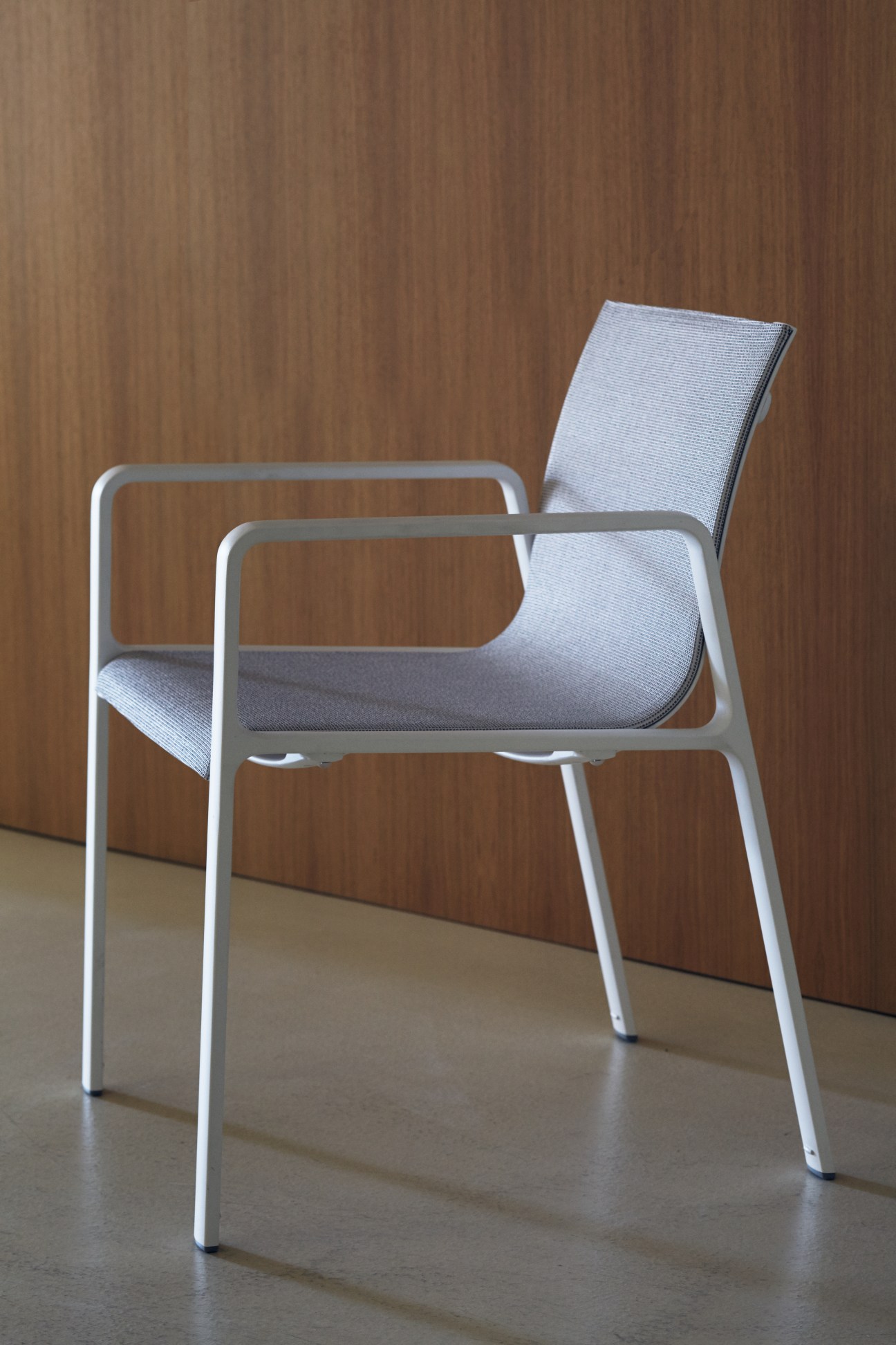 Park Life chair by Jasper Morrison with white aluminum frame and gray upholstered seat and back.