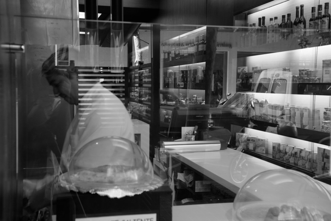 Interior of Semon in Barcelona showing shelved bottles and products behind counter with glass displays.