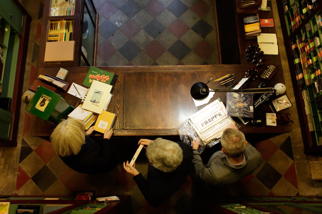 Overhead view of Fratelli Bonvini's original wood counter with customers browsing stationery products.
