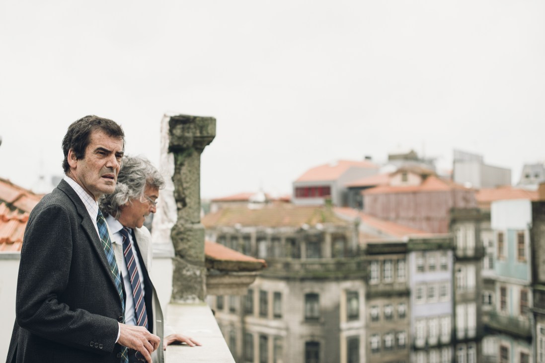 Porto's Mayor Rui Moreira and a companion overlook the city's historic center and rooftops from an elevated vantage point.