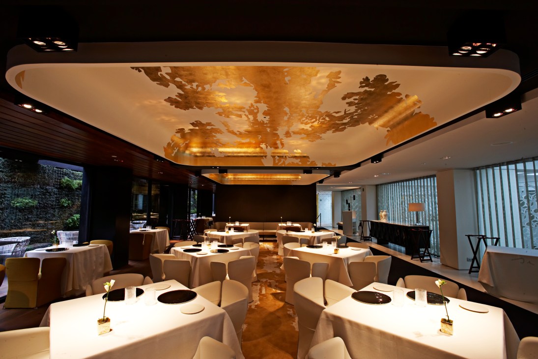 Modern fine dining restaurant with illuminated ceiling artwork at Mandarin Oriental Barcelona.