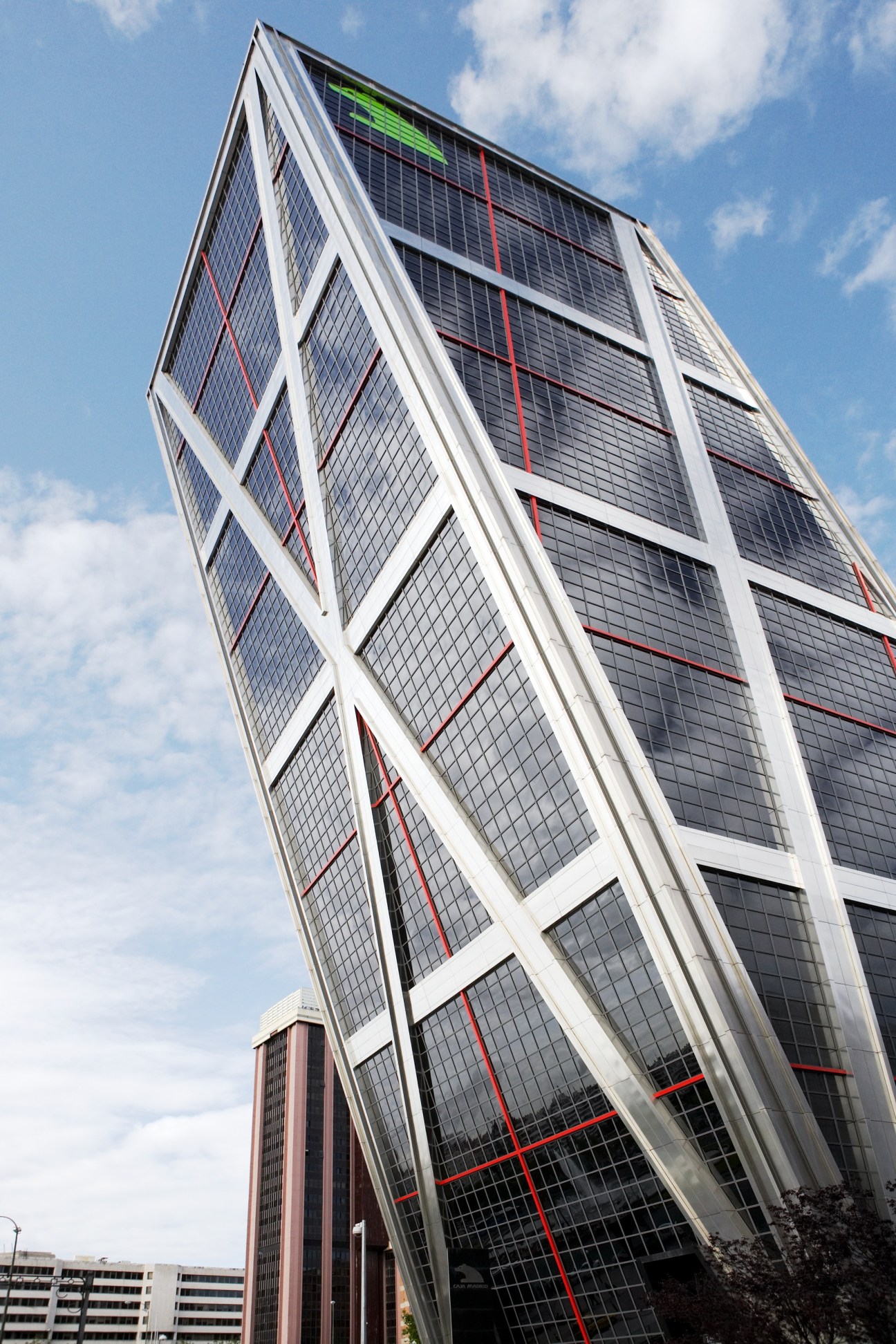 Caja Madrid tower in Puerta de Europa with tilted white frame and dark glass facade against blue sky