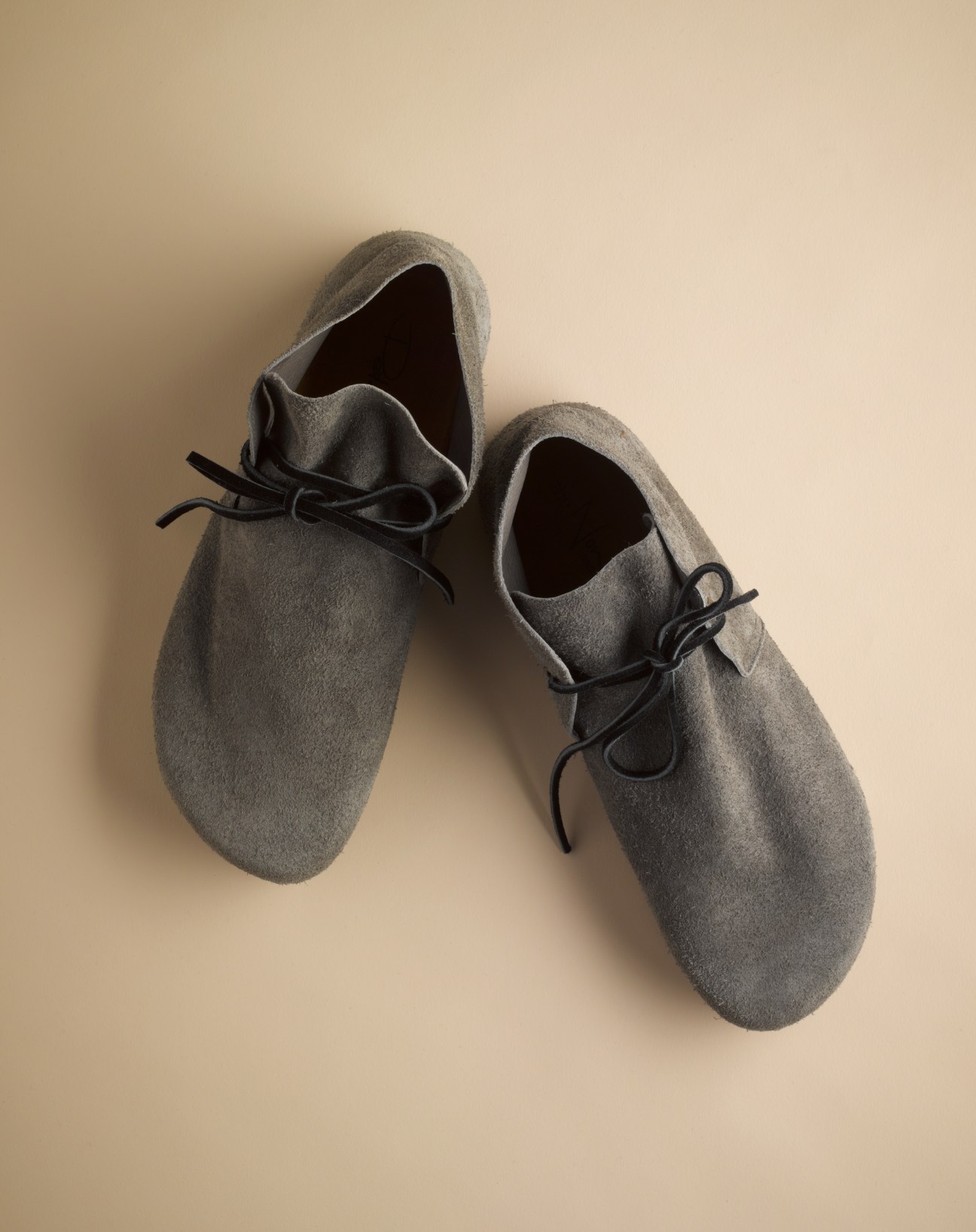 Pair of grey felt desert boots with black laces from Peter Non's Rodalquilar series.