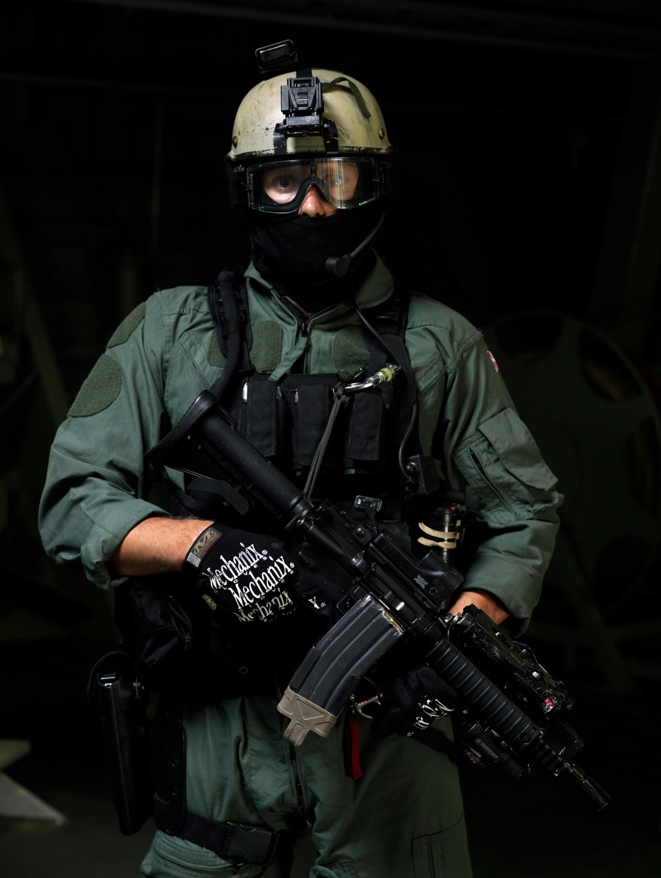 Danish Navy special forces Frogman in tactical gear with helmet, night vision goggles and rifle.