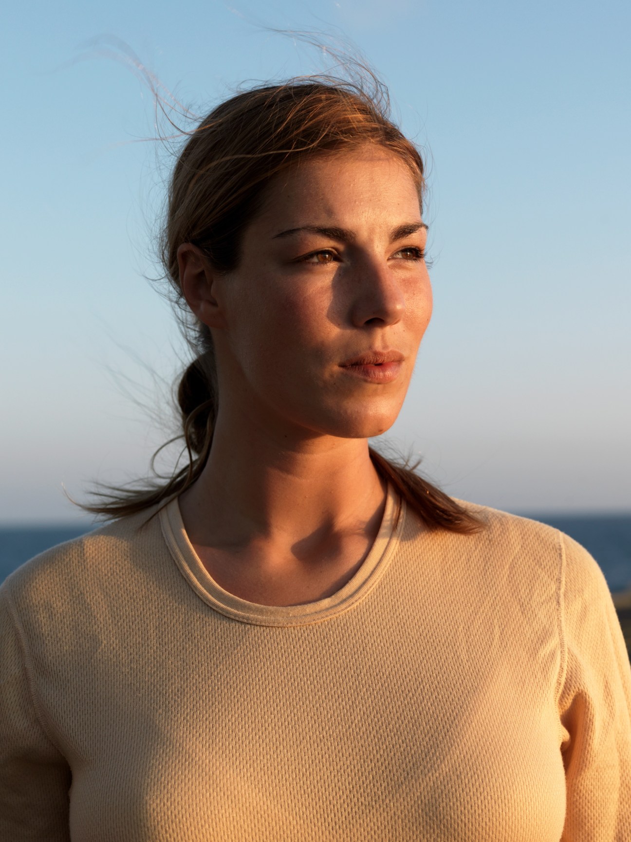 Ana Theresa Aagaard, helicopter launch team member, portrait with ocean horizon in background