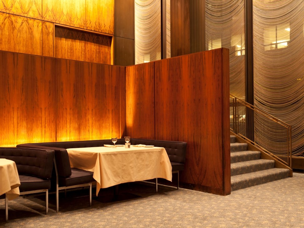 The Grill Room at Four Seasons restaurant in New York, featuring wooden divider screens and elegant dining setup.