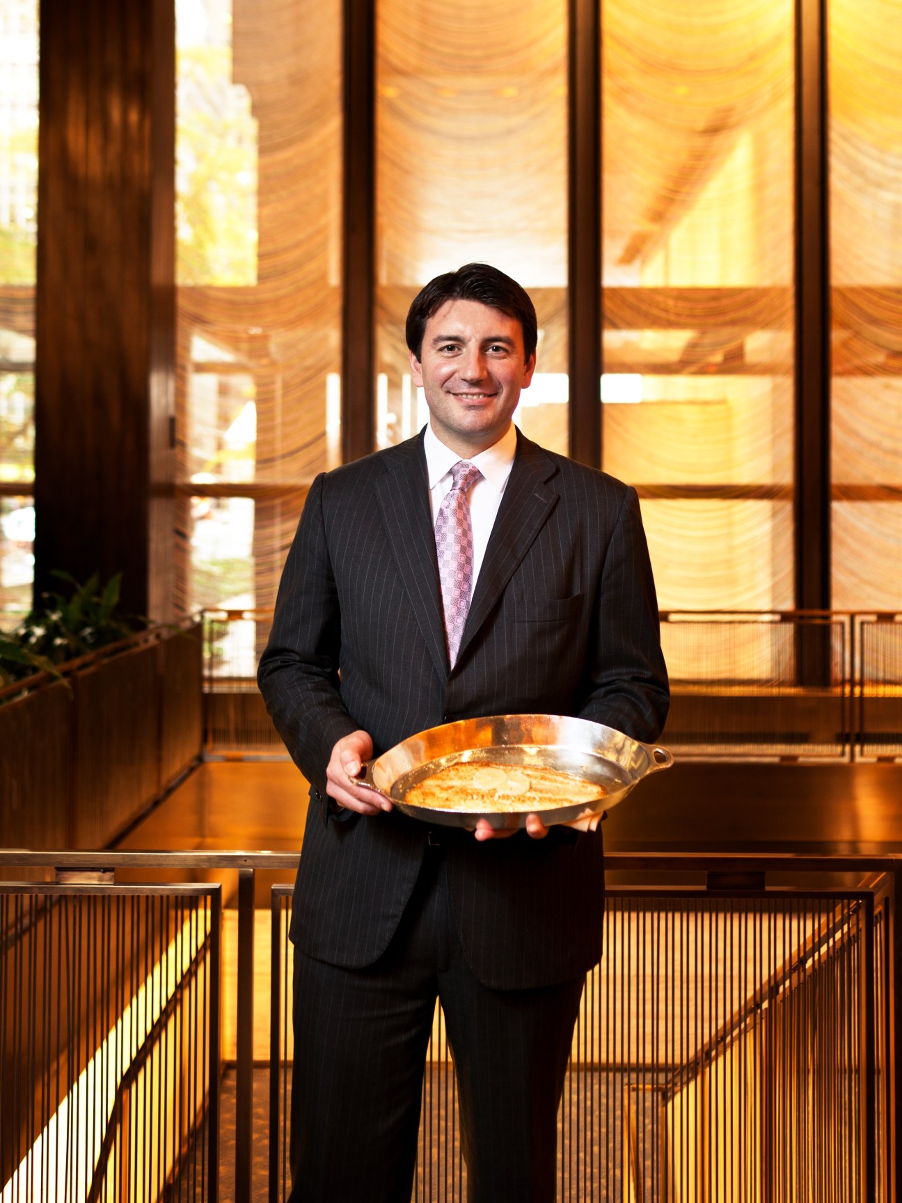 Assistant manager Ivan Matteoni holds a plate of risotto in The Four Seasons restaurant.