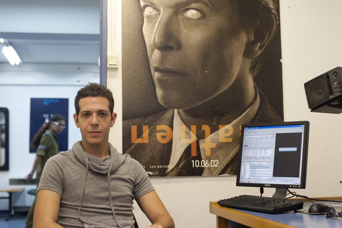 Or Tzelkovnik, musical manager at Galgalatz, seated at a workstation with computer monitor and keyboard.