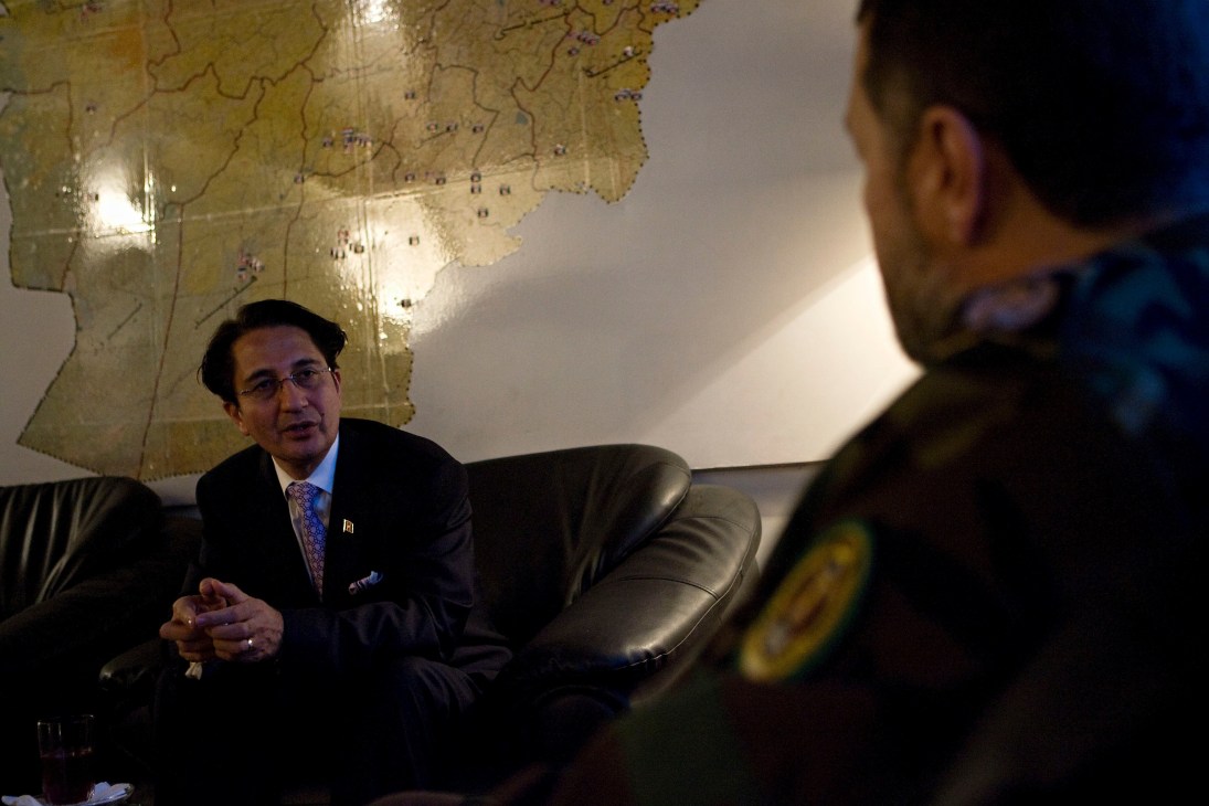 Afghan ambassador Said Jawad meets with military official Bismillah Khan in front of an Afghanistan map.