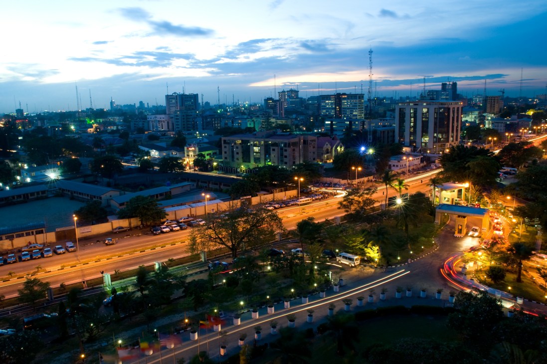 Lagos cityscape at dusk showing illuminated streets, buildings and skyline.