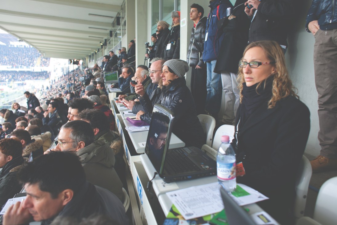 Alessandra Bocci watches a football match from the press box at Dino Manuzzi stadium with a laptop and notepad.