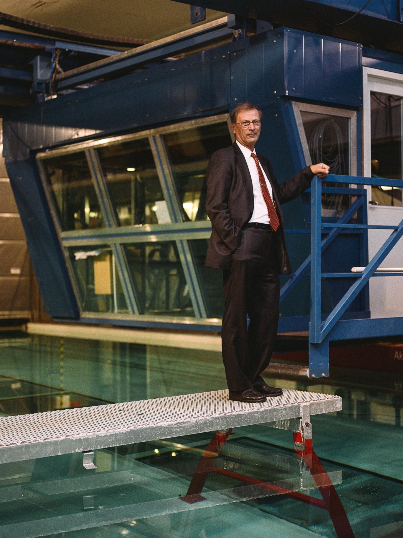 Mikko Niini, managing director of Aker Arctic, stands beside an ice-testing tank at the company's Helsinki facility.
