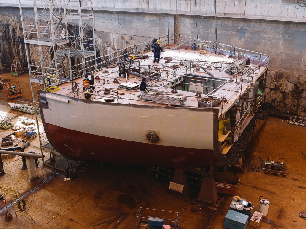 Icebreaking vessel under construction at Arctech Helsinki Shipyard, showing the asymmetric hull design allowing sideways ice-cutting operations.