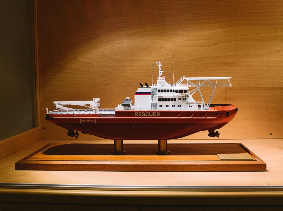 Model of icebreaking multipurpose emergency and rescue vessel displayed on wooden stand