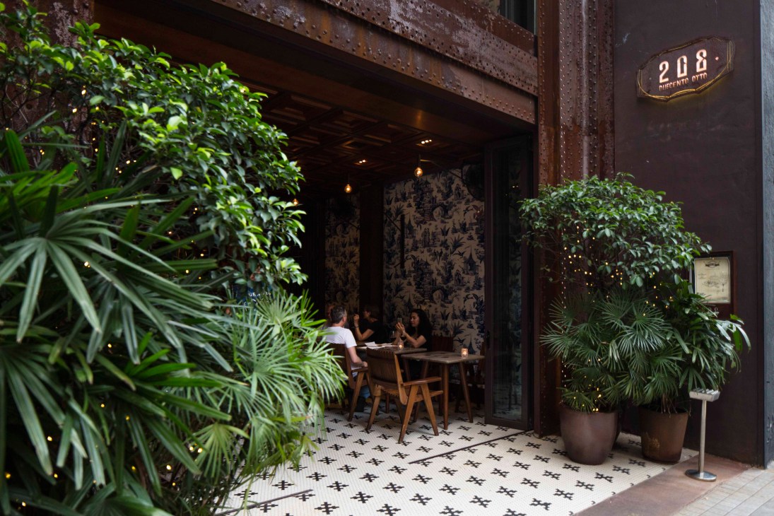 208 Duecento Otto restaurant entrance on Hollywood Road with tropical plants and patterned tiles.