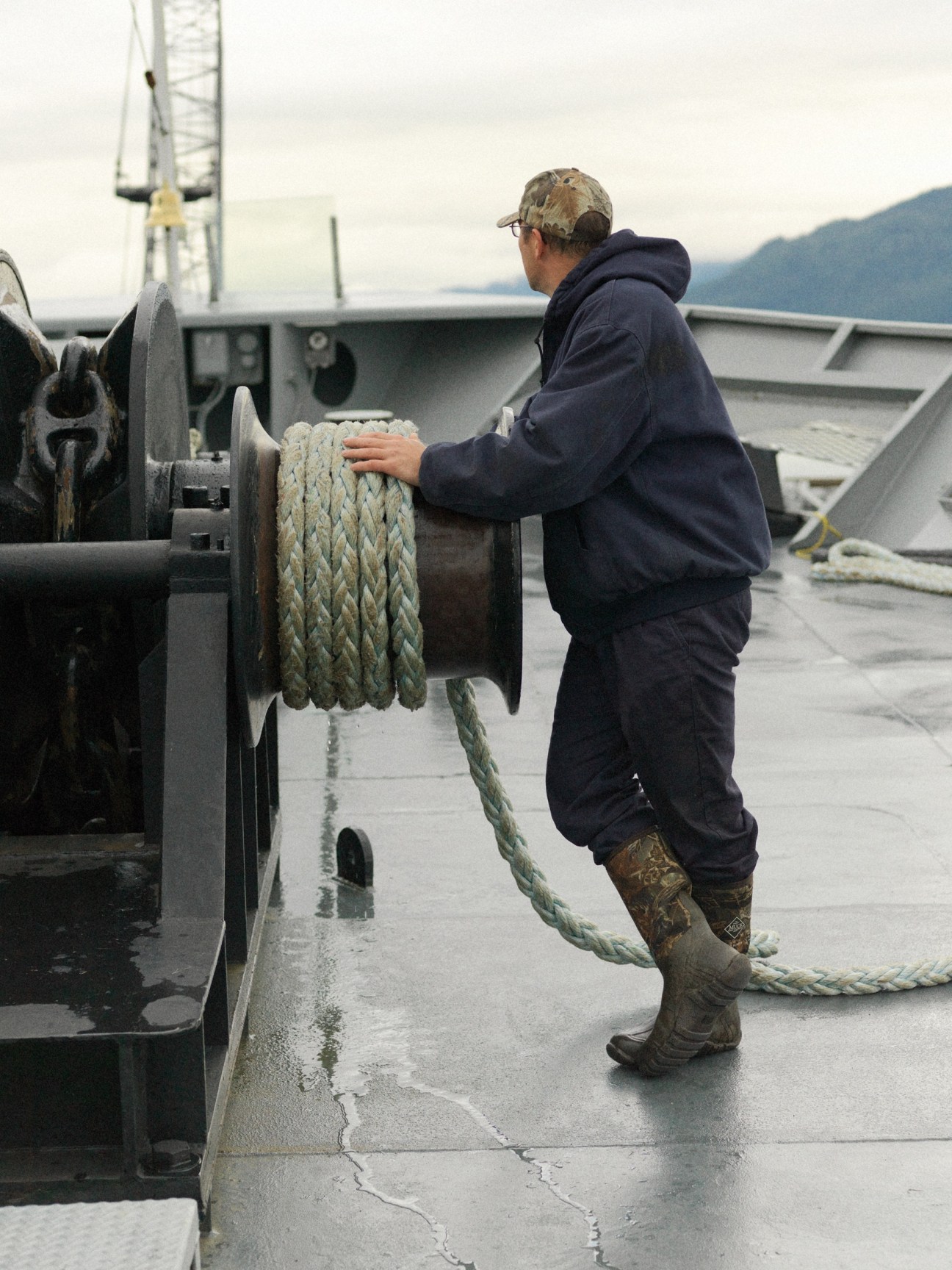 A crew member operates a deck winch to tighten mooring lines on the M/V Columbia ferry.