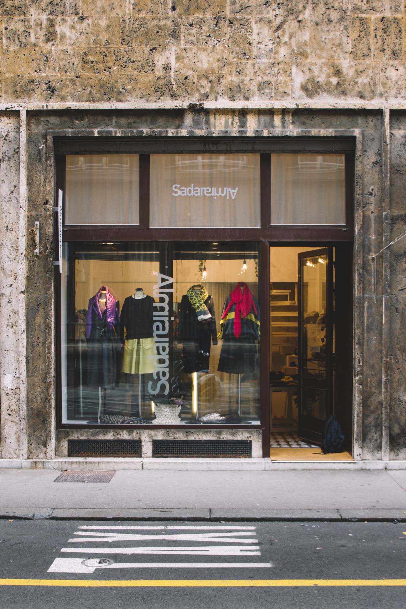 Almira Sadar fashion boutique storefront with colorful dresses displayed in windows