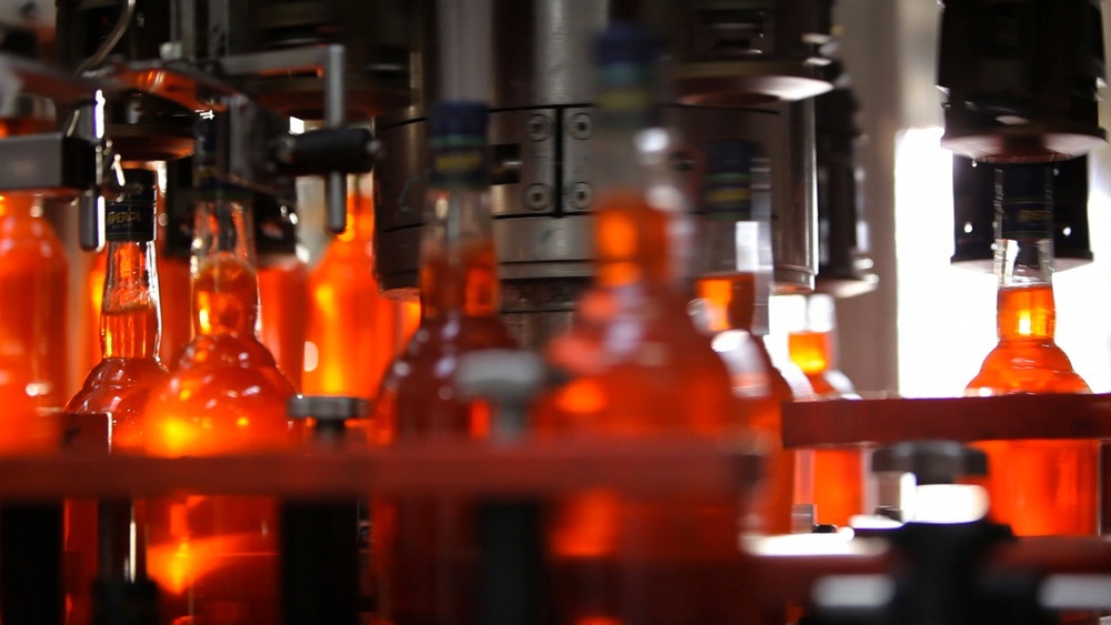 Bottles of Aperol liqueur on an assembly line at Gruppo Campari production facility.