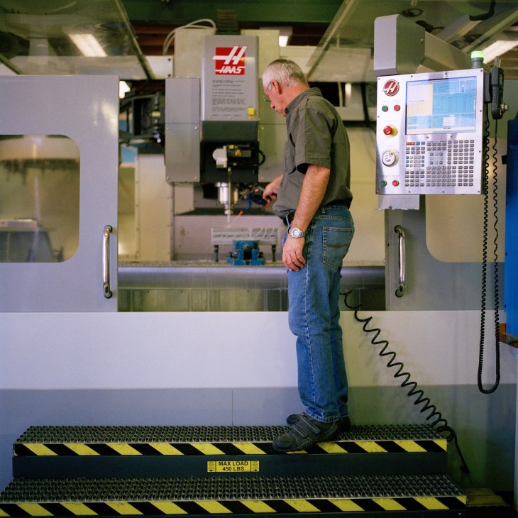Jan Alberts, machinist, operates a Haas CNC machine at Aerosud manufacturing facility.