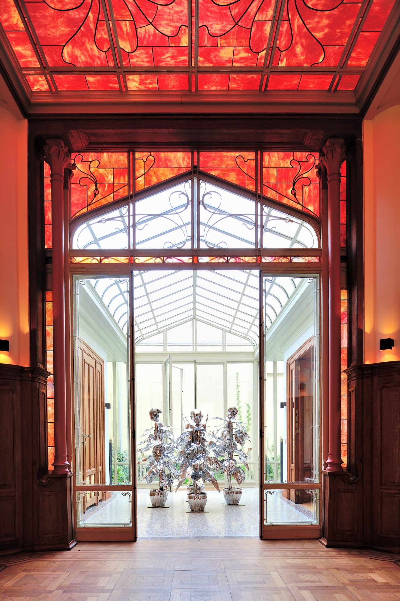 Art nouveau glass doors and red stained-glass ceiling at Galerie Paris-Beijing's Brussels gallery designed by Victor Horta.