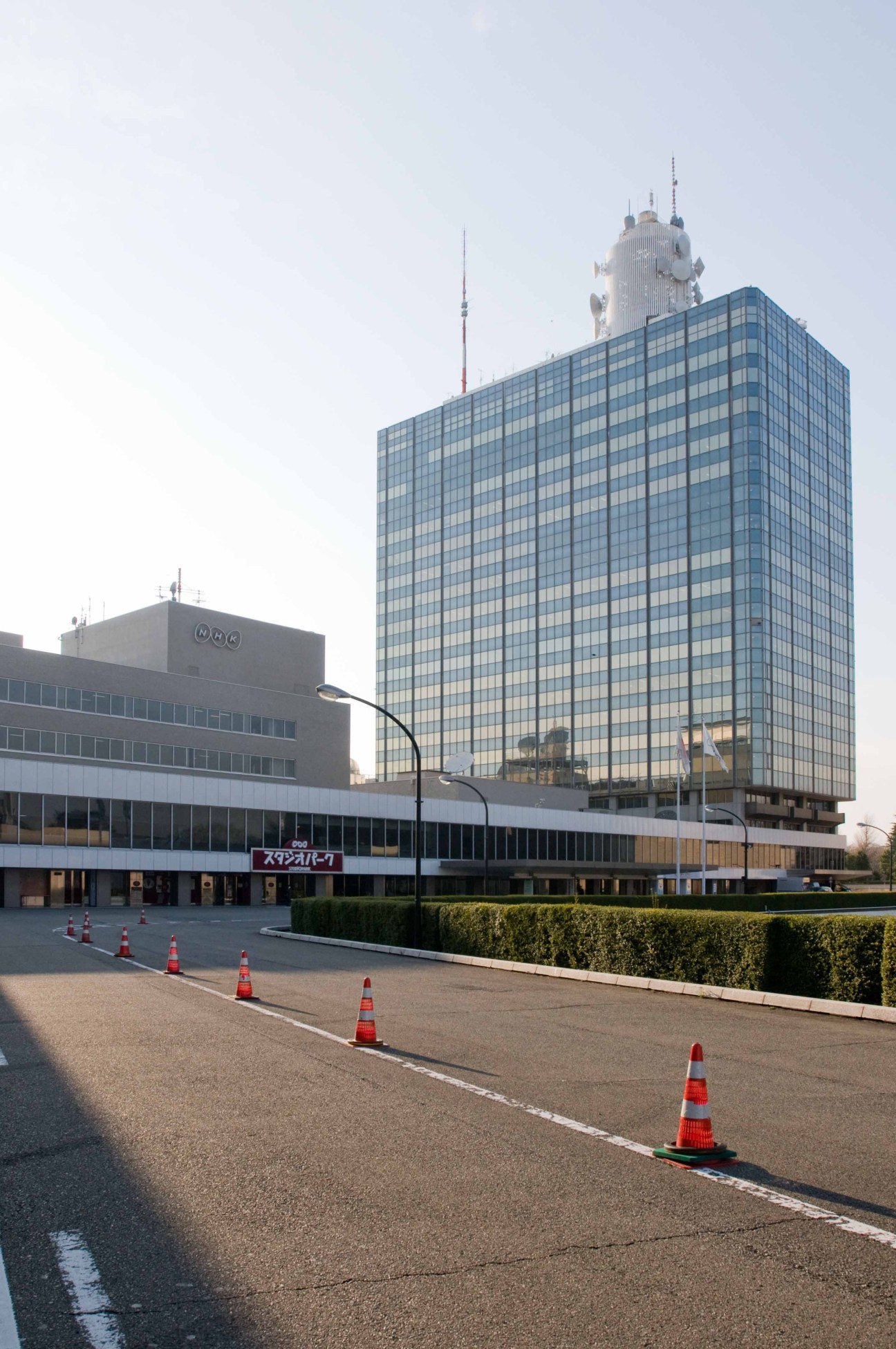 NHK's headquarters and main studios in Tokyo, a modern multi-story glass building with broadcasting antennas on the roof.