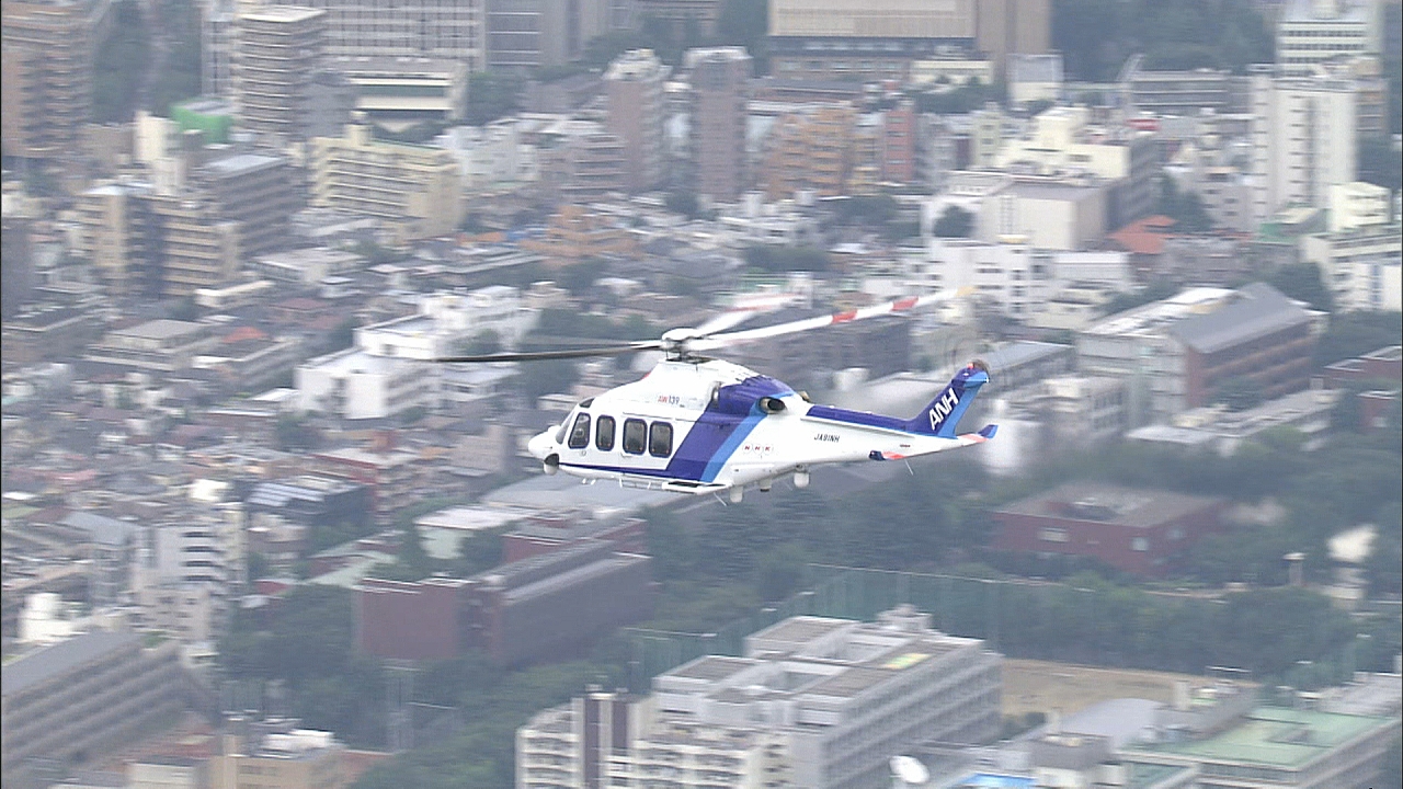 NHK helicopter flying over Tokyo cityscape during disaster coverage operations.
