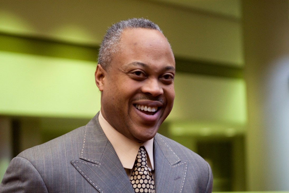 Bernard Bronner, president and CEO of Bronner Brothers, smiling in a grey suit and patterned tie.
