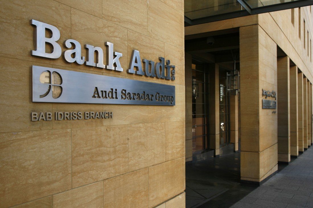 Bank Audi storefront with signage on stone facade and glass entrance doors.