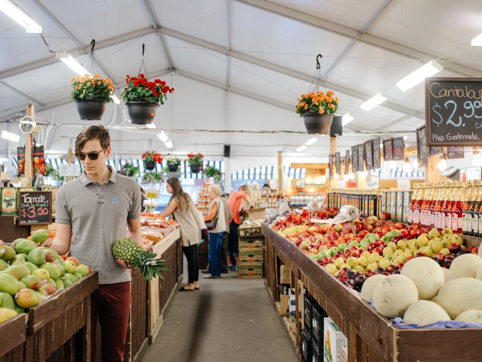 Man shopping for fresh produce at Jean-Brillant, Montreal's 24-hour farmers' market.