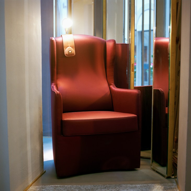 Red leather Luis armchair with reading lamp in Azucena showroom