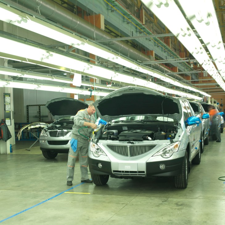 Worker assembling SsangYong jeeps on production line at Sollers factory in Vladivostok.